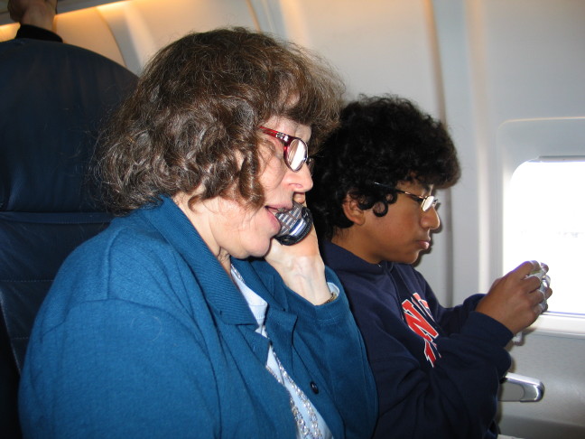 Image of Mary Jane on cell phone on plane